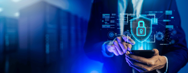 A man in a suit holding a locked phone.