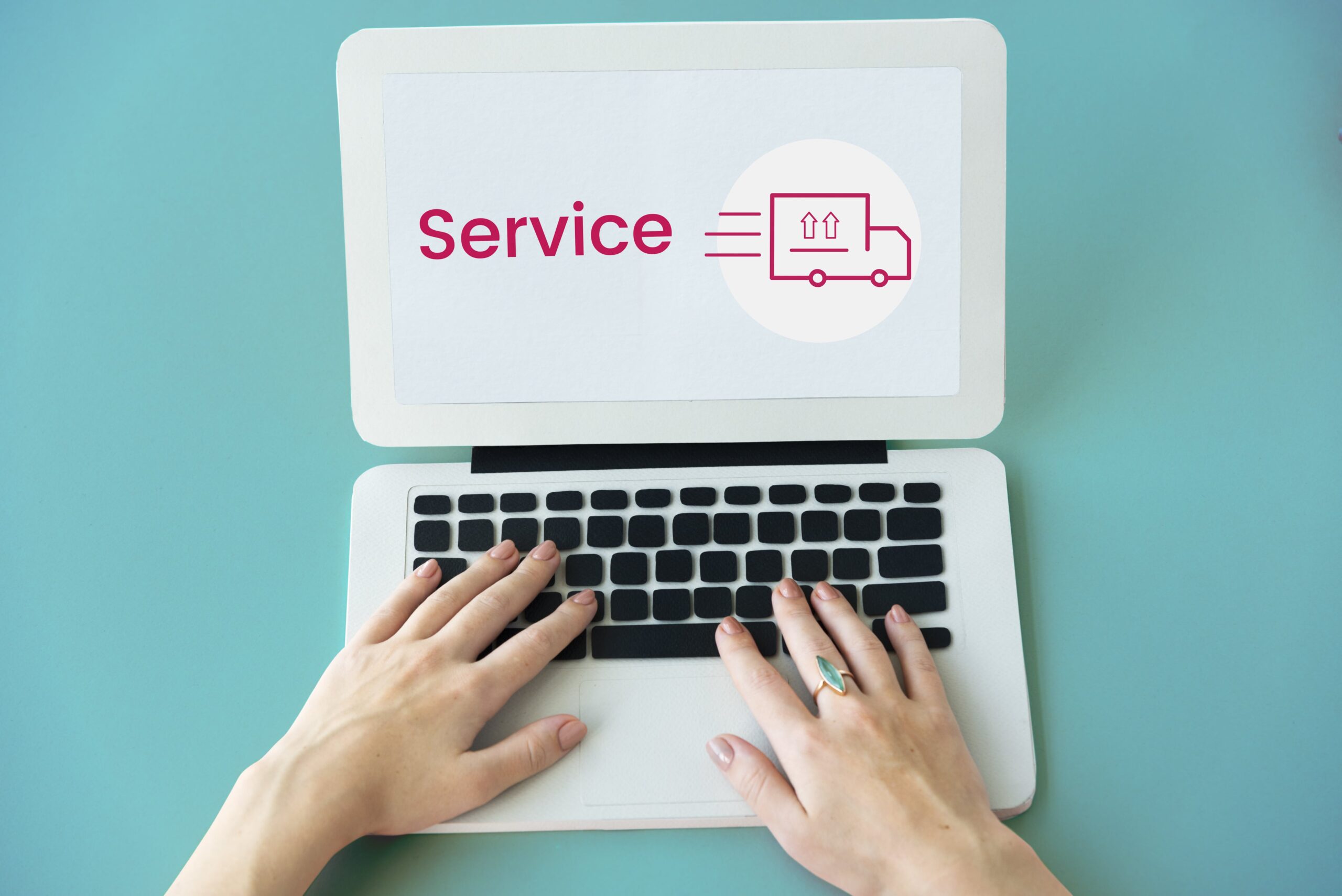 A woman typing on a laptop, discovering how to make money through drop servicing.